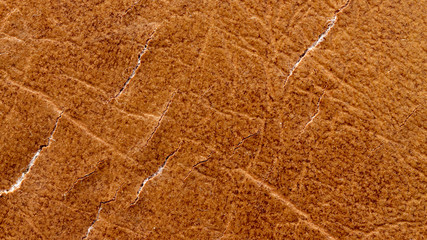 Brown leather material with cracks as background