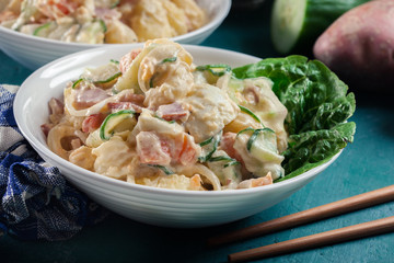 Delicious potato salad with ham, egg and cucumber