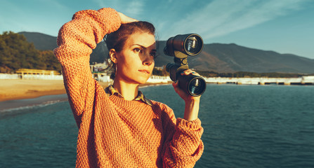 Beautiful Girl With Binoculars In Hand Standing By The Sea And Enjoying View Of Summer Nature