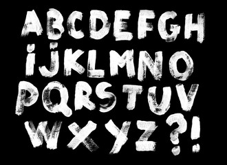 Alphabet set of white capital handwritten letters on a black background. Drawn by semi-dry brush...