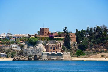 View of a fort above the beach along the Arade River, Portimao, Algarve, Portugal.