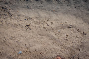 Wave of the sea on the sand beach, summer sand beach background with footprint