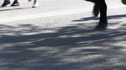 Marathon runners legs on asphalt road