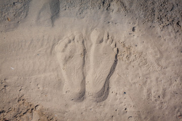 Wave of the sea on the sand beach, summer sand beach background with footprint