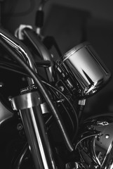 Fototapeta na wymiar Closeup of chopper's chrome handlebar, fork, and actuator. Black and white