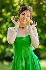 Fototapeta premium Beautiful young asian woman with kiwi