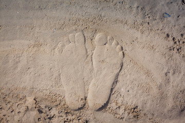 Wave of the sea on the sand beach, summer sand beach background with footprint
