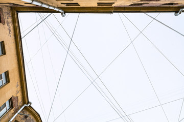 Obraz premium electrical wires and cables over apartment house