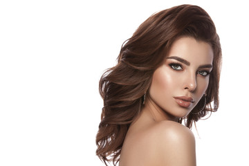 Naklejka premium Beauty portrait of a young girl with natural make-up and natural lip color. Hairstyle curls, chestnut hair color. White isolated background.