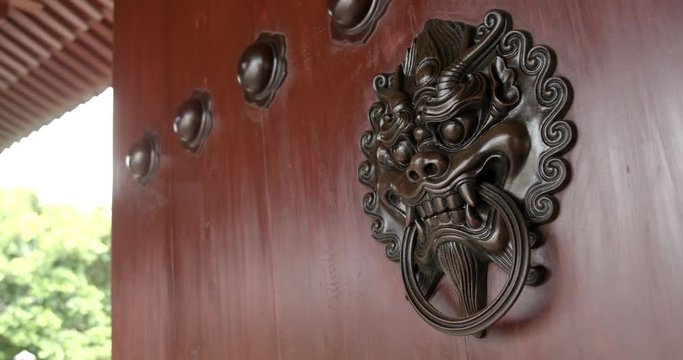 Lion statue door lock with traditional chinese building decoration