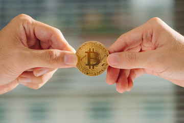uncertainty with bitcoin in hand,war of bitcoin,pull bitcoin with hand to hand, many bitcoins up,on bokeh,white,blue,purple light background, bitcoins in businees man hand