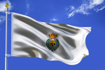 The white silk waving flag of Santa Cruz de Tenerife city with a flagpole on a blue sky background with clouds .3D illustration.