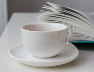 White cup and book