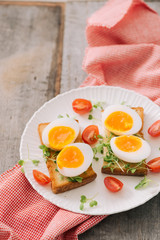 freshly boiled white egg on wooden board. Healthy fitness breakfast.