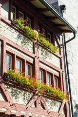 Fototapeta na wymiar Medieval house with many flower pots, Stein am Rhein, Switzerland