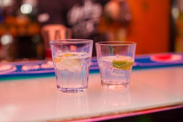 Cocktail with lime on a bar counter