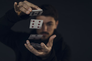 Magician conjuring with playing cards, close-up