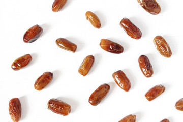 Styled stock photo. Ramadan desktop composition with date fruit on white background. Food pattern. Empty space. Flat lay, top view.