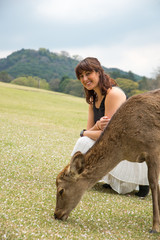 Young adult woman smiling with deer