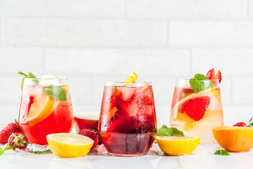 Cold white, pink and red sangria cocktails with fresh fruits, berries and mint.