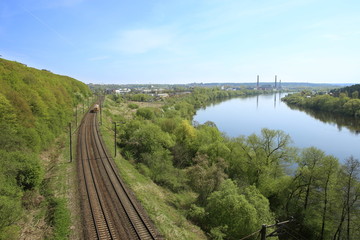 Landscape with railway and river. Railway line near river Nemunas in Lithuania.