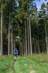 Obraz premium People running through a forest 