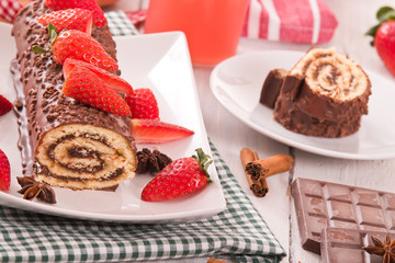 Chocolate roll with strawberries. 