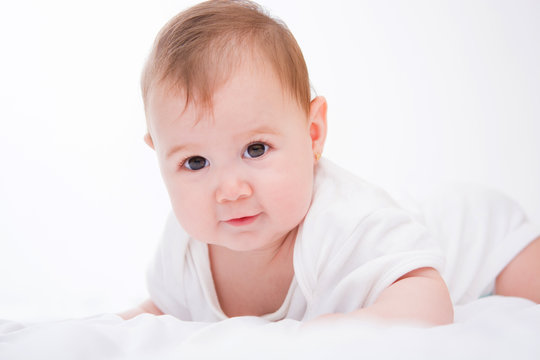 Adorable little baby girl on white background.