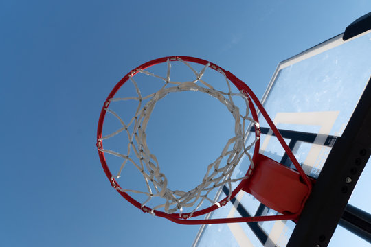 Basketball hoop photographed from below on a beautiful summer day