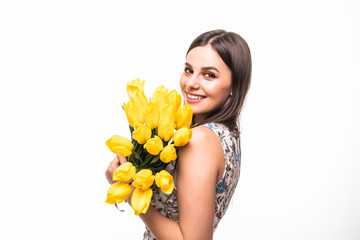 Happy young woman with yellow tulips isolated on white background
