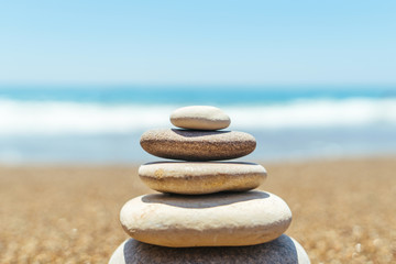 Fototapeta na wymiar Stack of zen stones on the beach near sea