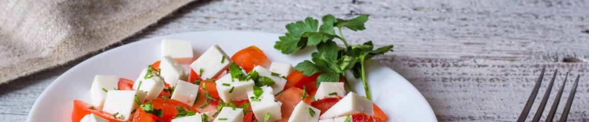 Banner of Fresh salad with tomato, mozzarella and herbs.