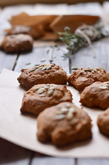 Home made pumpkin scones Cookies decorated with seeds lie on paper for packaging