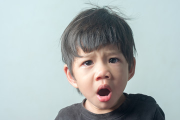Cute Asian Little boy yawn.
