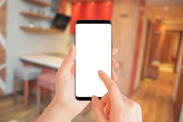 Girl using phone with isolated screen in hotel apartment. Travel concept, mockup