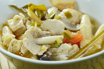 spicy boiled chicken with straw mushroom Tom Yum Soup on bowl