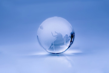 Globe is made of glass isolated on a blue background