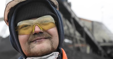 Coal miner, portrait of a young miner or stoker in the workplace.