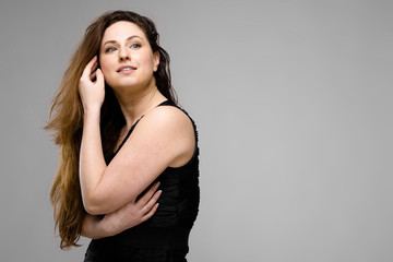 Fototapeta premium Attractive overweight woman in fashionable clothes