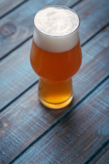 Pale ale on blue wood