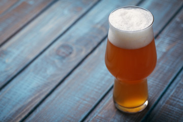 Pale ale on blue wood