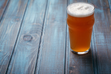 Pale ale on blue wood