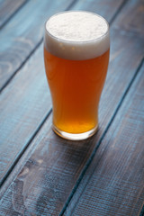 Pale ale on blue wood