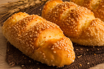 tasty sesame bread put on table,sesame bread and wheat put on sackcloth,select focus