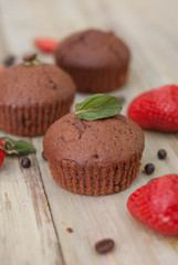 Chocolate Muffins with Strawberry Mint Leaves over rustic Gray Background Breakfast desert