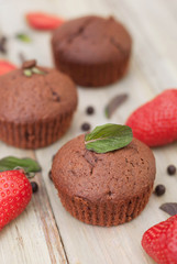 Chocolate Muffins with Strawberry Mint Leaves over rustic Gray Background Breakfast desert