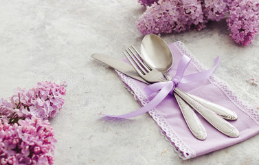 Spring table decoration with lilac flowers