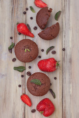 Chocolate Muffins with Strawberry Mint Leaves over rustic Gray Background Breakfast desert