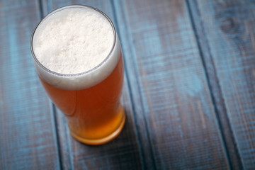 Pale ale on blue wood
