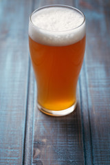 Pale ale on blue wood